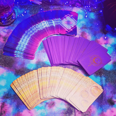 circular image of tarot cards fanned out on tablecloth